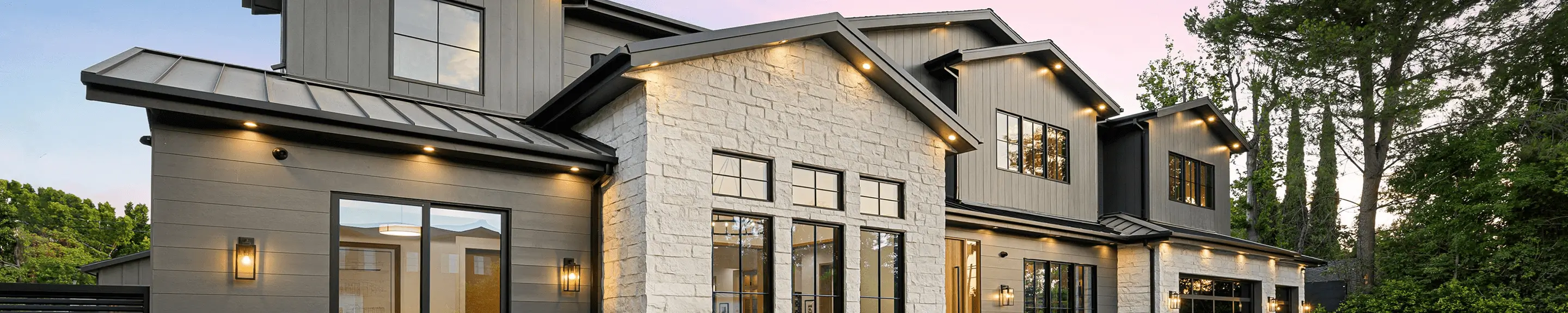 Contemporary house with stone gable and lights
